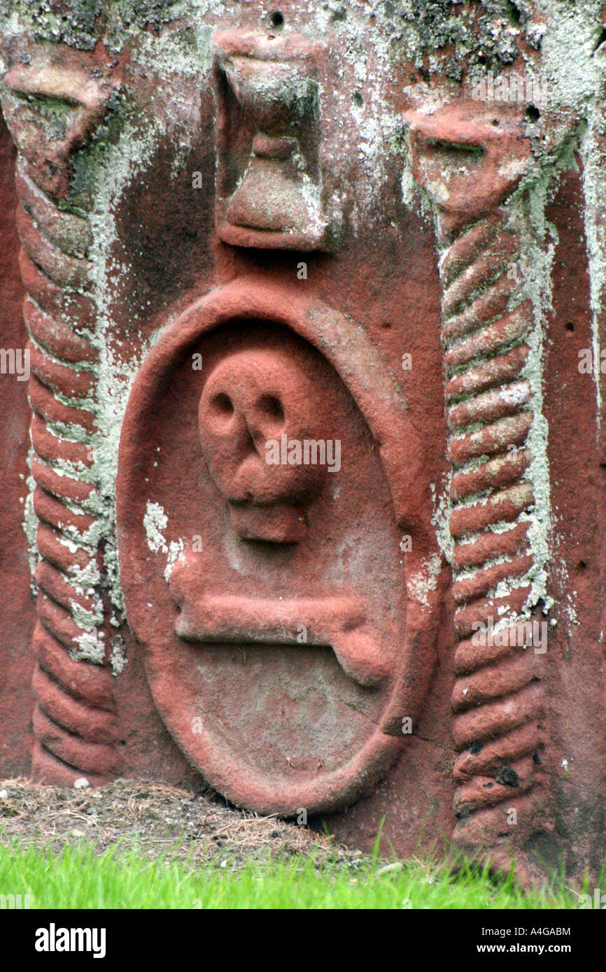 Skull in stone tomb in old scottish graveyard Stock Photo