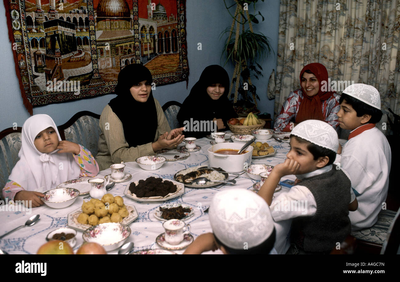 Muslim family celebrating end of Ramadan with meal called Iftar which ends the fast also known as Eid Stock Photo