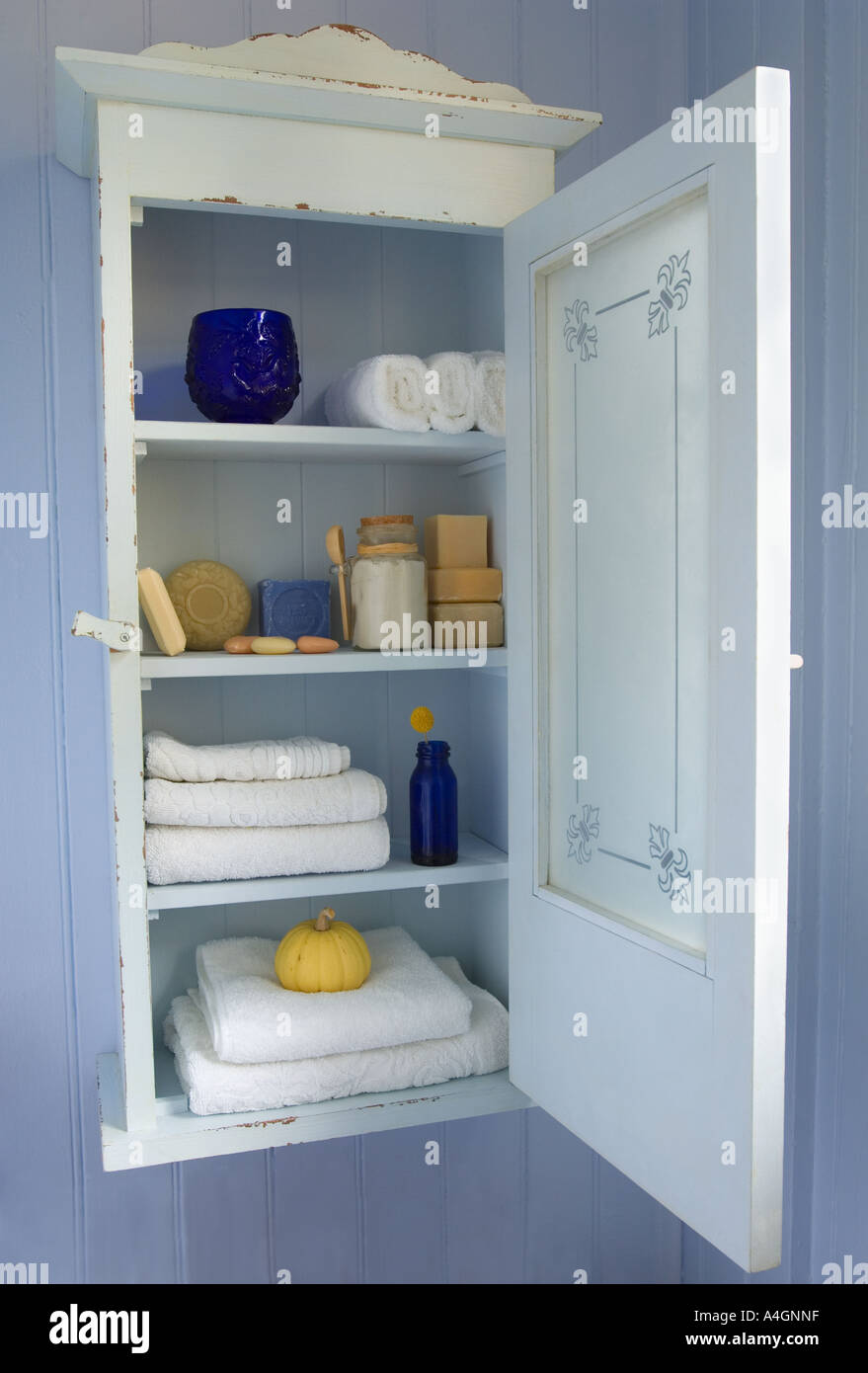 Bathroom detail with a distressed metal storage cabinet topped with  toiletries in glass jars Stock Photo - Alamy