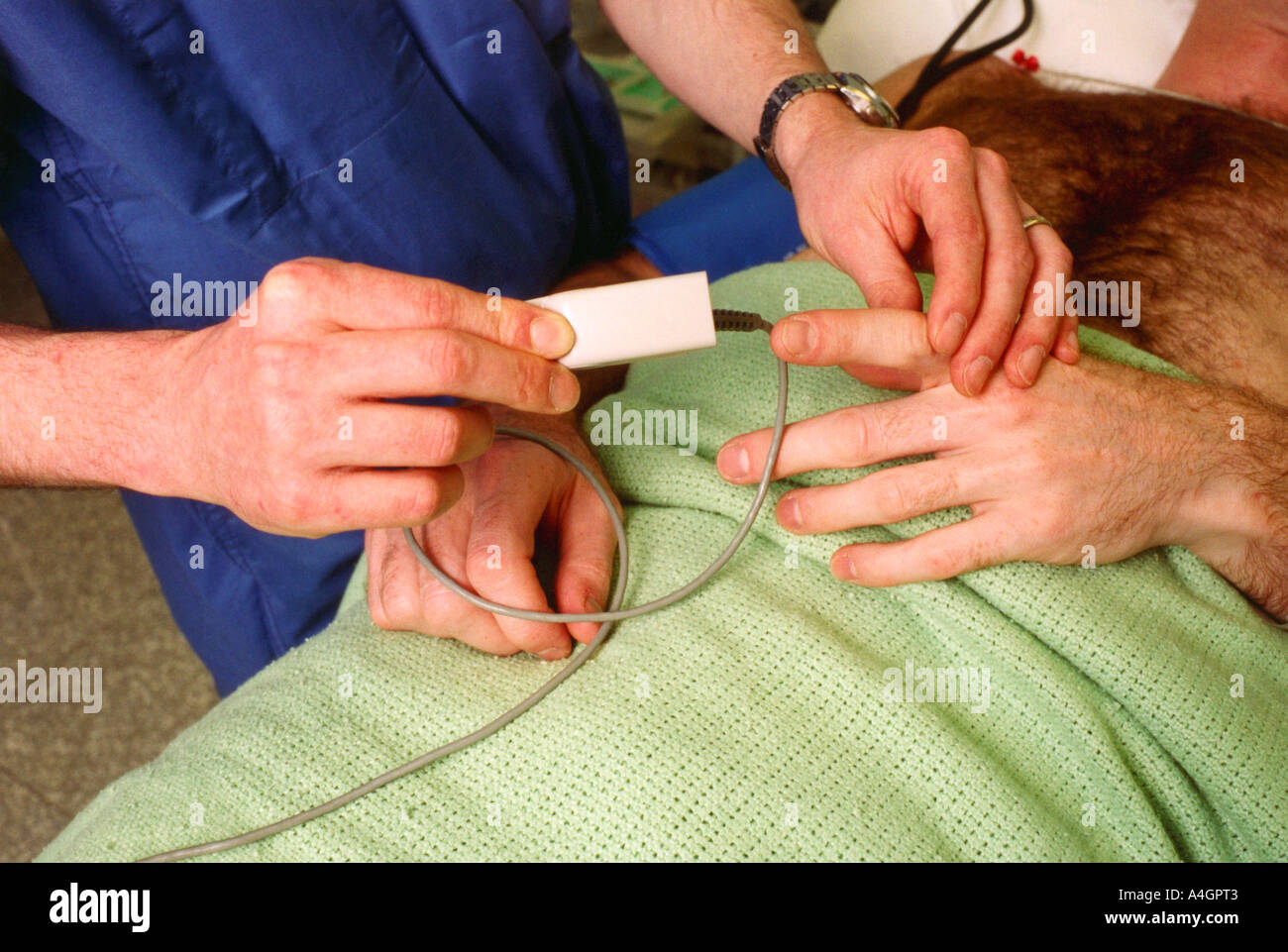 pulse oximeter finger probe plethysmography pulse oximetry monitoring non invasive photograph patient anaesthesia anaesthetic ro Stock Photo