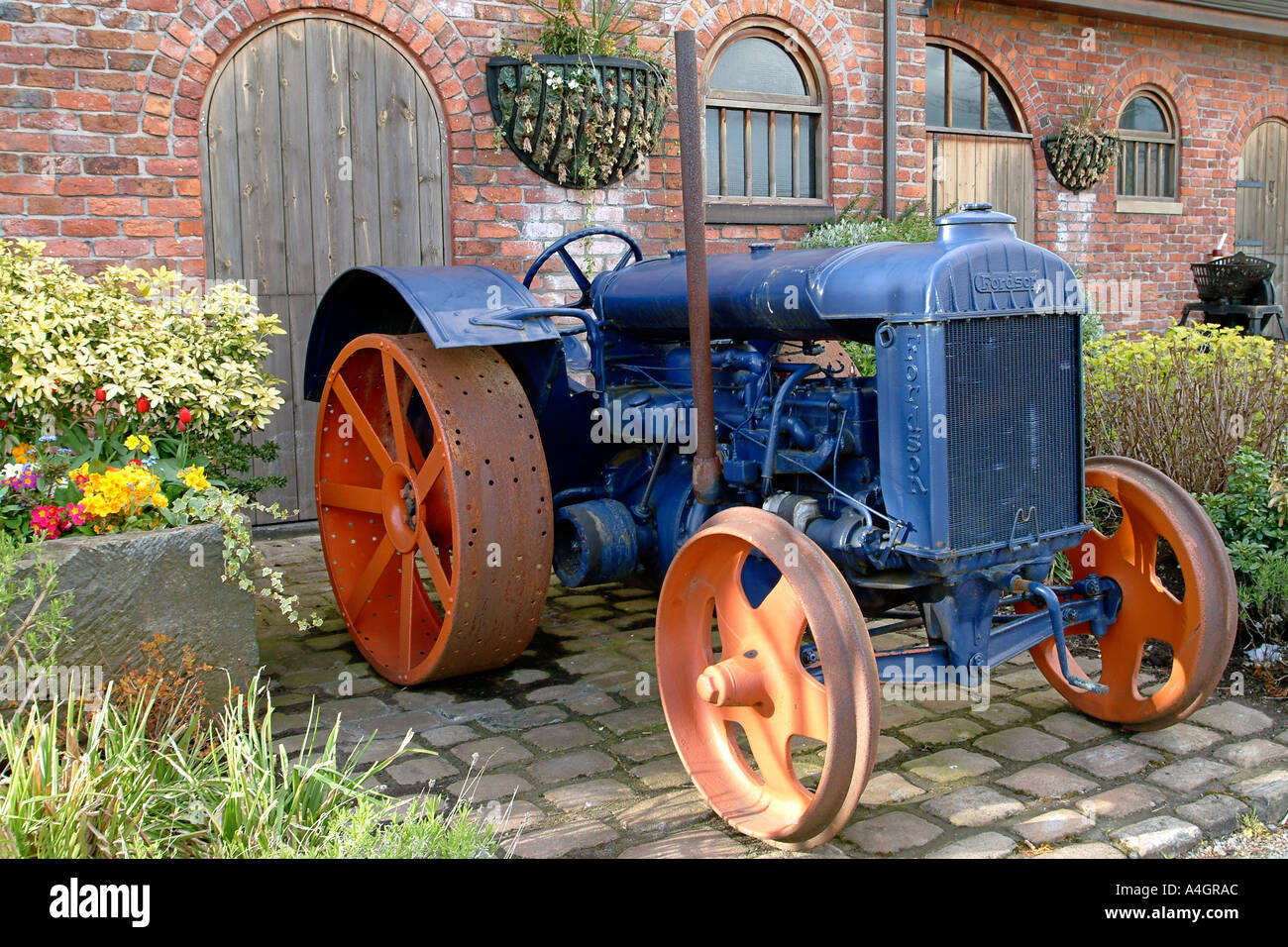 An old tractor stands outside the Bredbury Hotel (formerly the Bradburie Hall) near Manchester in England. Stock Photo