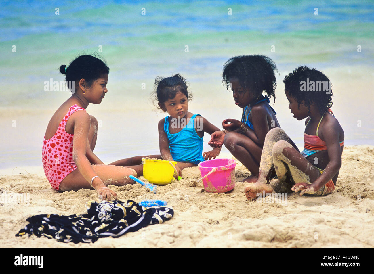 FOUR YOUNG GIRLS PLAYING ON FLIC EN FLAC BEACH MAURITIUS ISLAND Stock ...