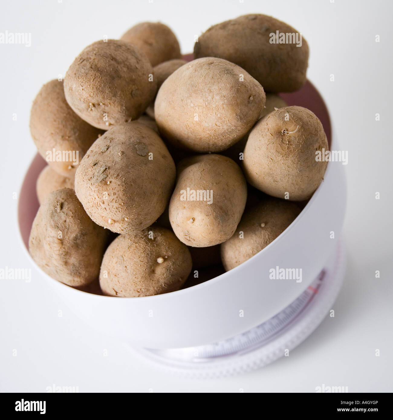 Potatoes in a kitchen scale Stock Photo Alamy
