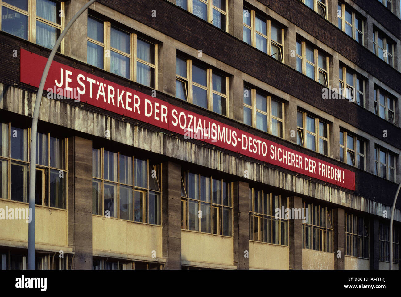 Socialist propaganda at a facade, East-Berlin, GDR Stock Photo