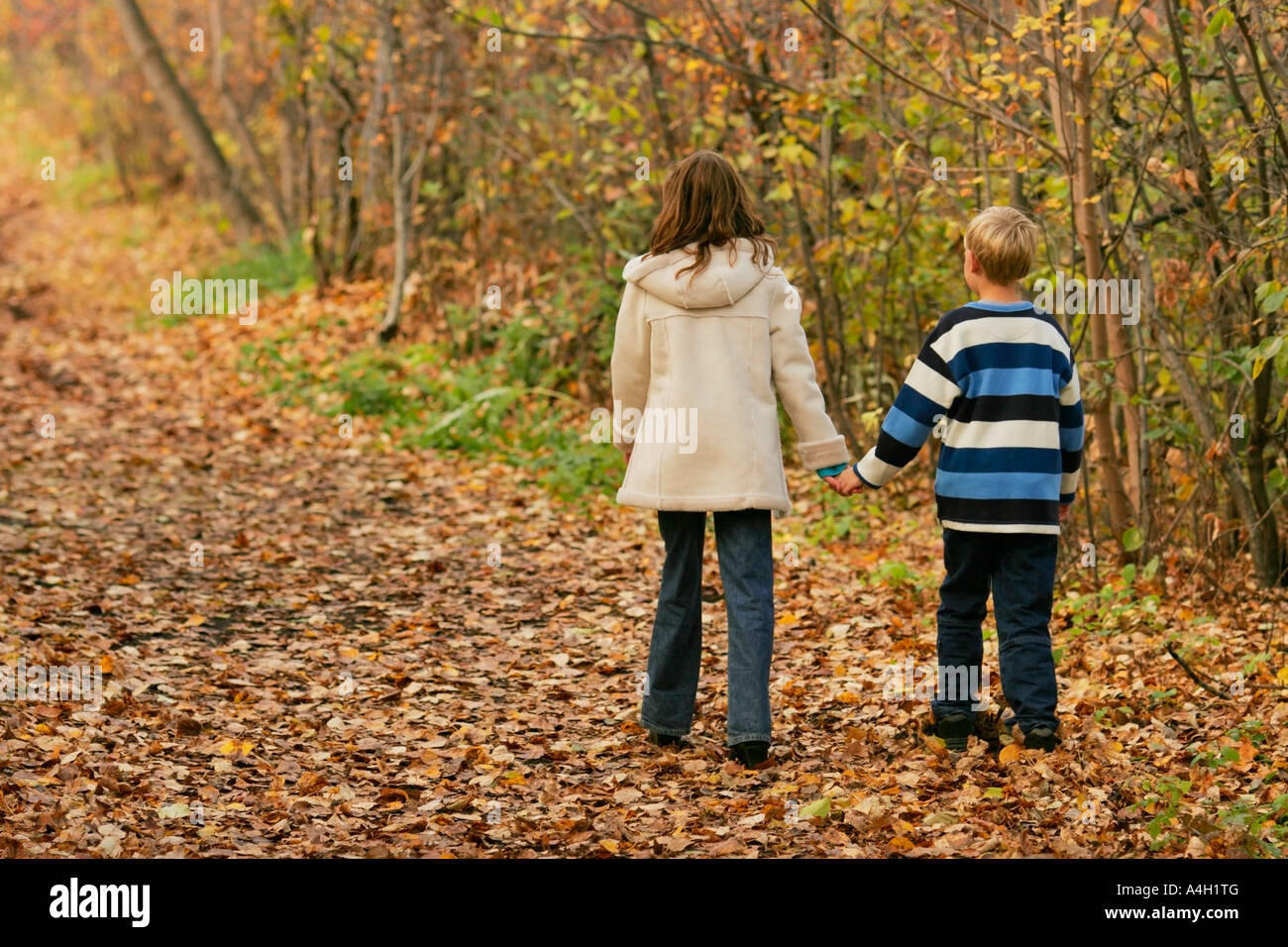Boy and girl holding hands Stock Photo - Alamy