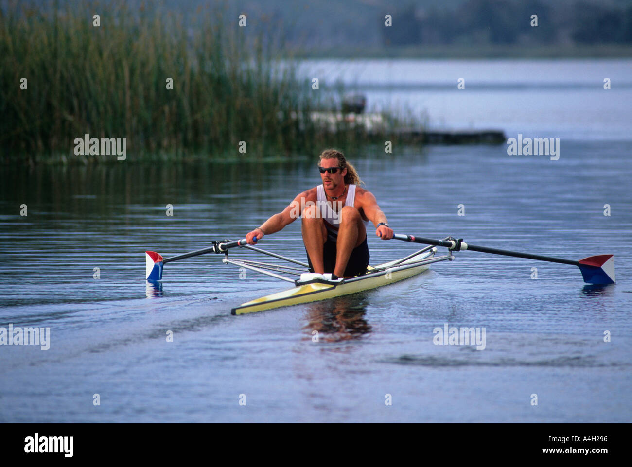 A man rowing a single scull rowboat Stock Photo 2036373 Alamy