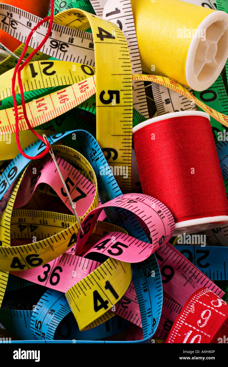 Measuring tapes and thread with needle Stock Photo