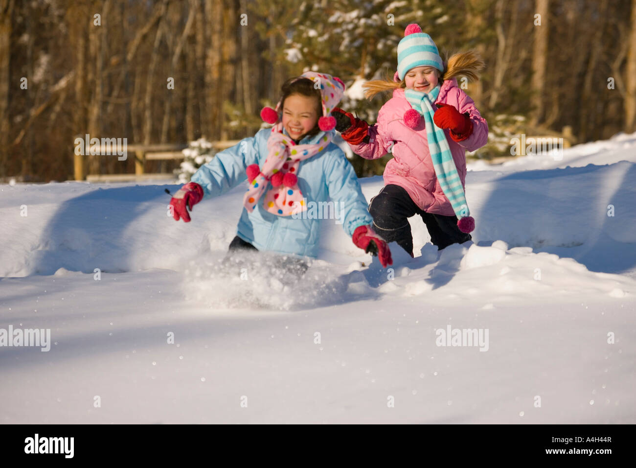 Girls running in the snow Stock Photo Alamy