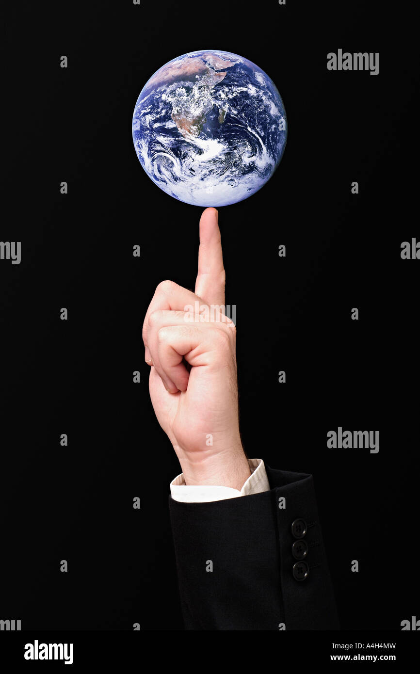 Planet Earth on the Finger of a Businessman Global Commerce Concept Stock Photo