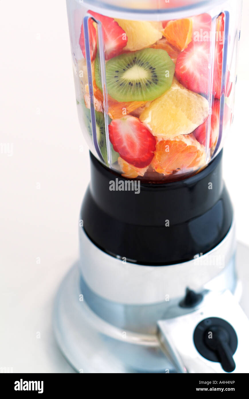 Mixed Fruit in a Blender Ready to be made into a Healthy and Refreshing Drink Stock Photo