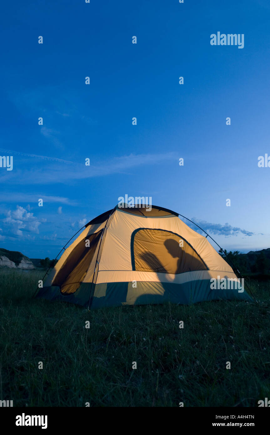 Reading in a tent in Theodore Roosevelt National Park in North Dakota Stock Photo