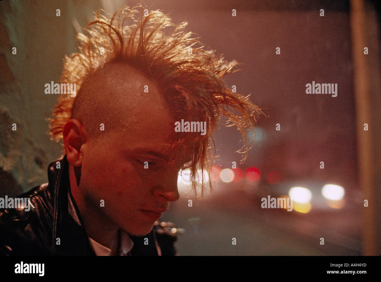 Young Man With Mohawk Haircut Smokes A Cigarette Outside An
