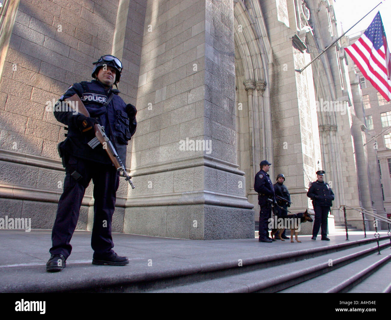 Armed NYPD officers stand guard in front of St Patrick s Cathedral  Stock Photo