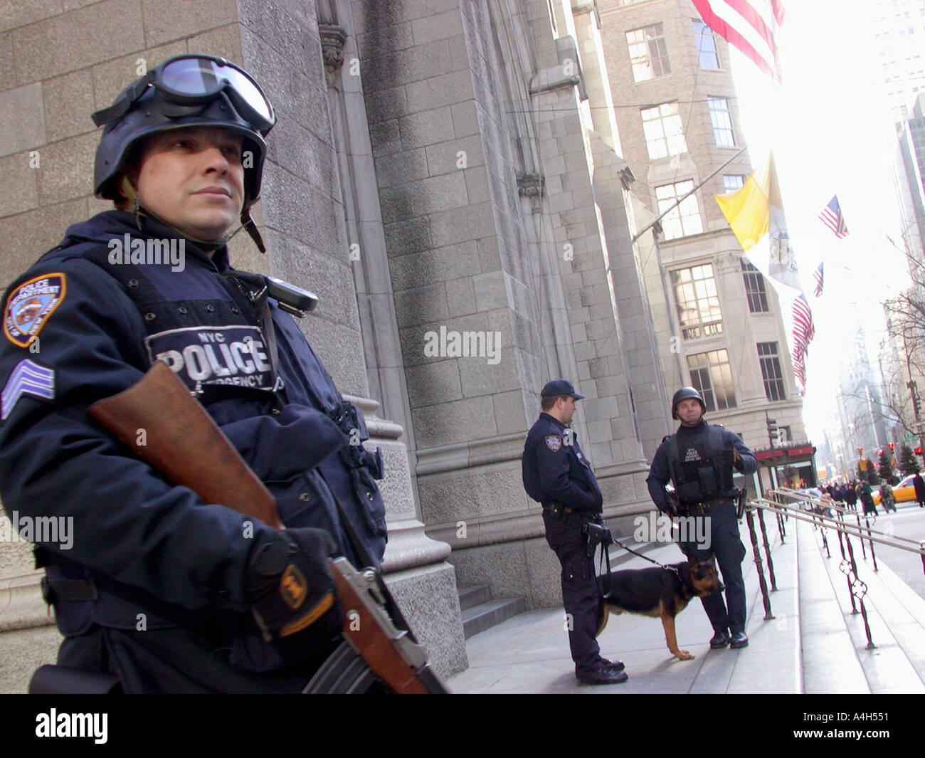 Armed NYPD officers stand guard in front of St Patrick s Cathedral  Stock Photo