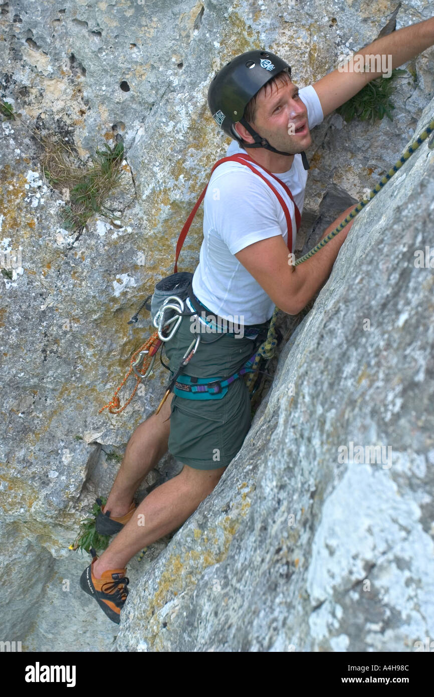 sweating rock climber with exhaustion and fear in his face Model