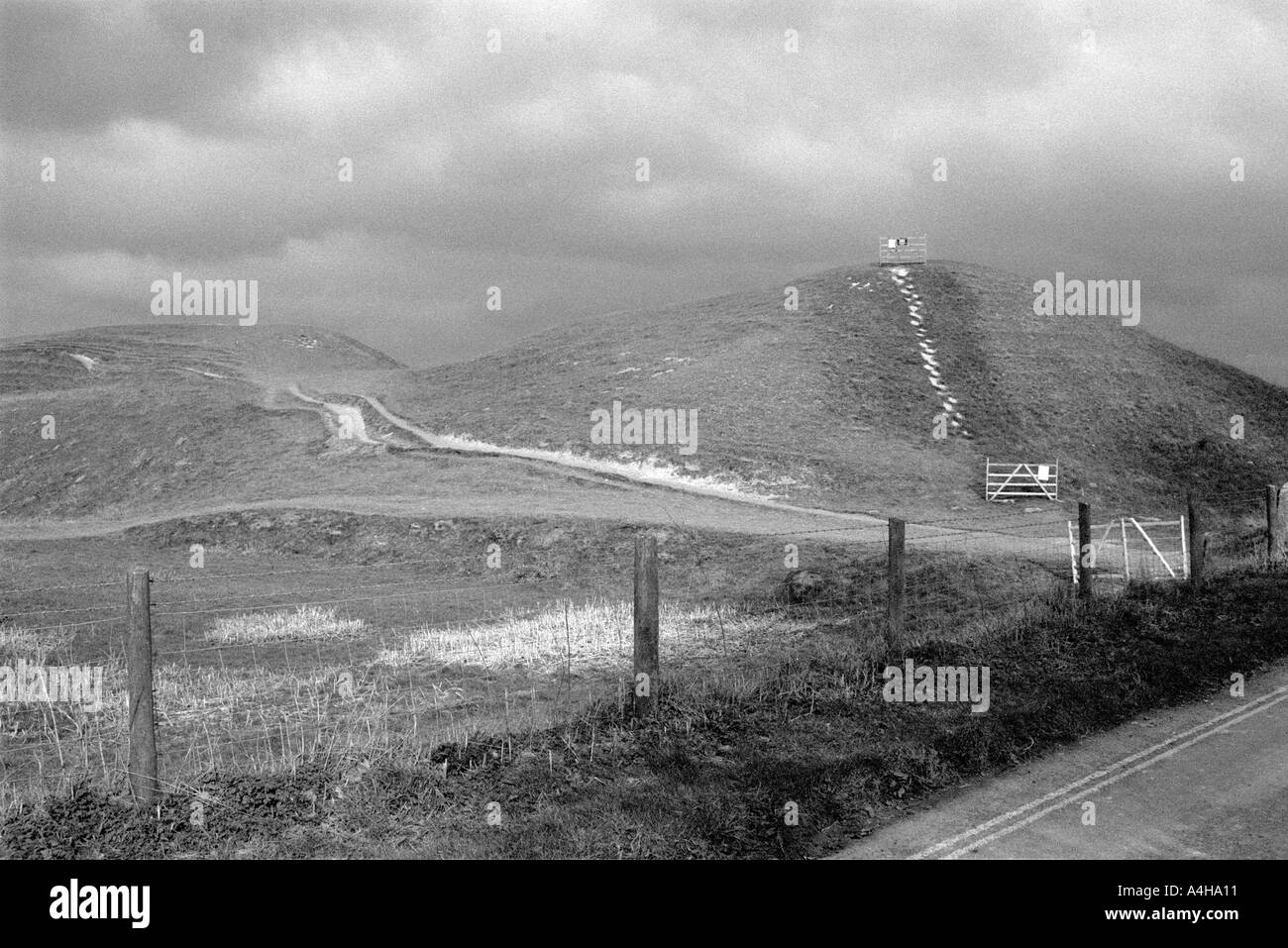 Earthwork and brooding clouds Avebury Stone Circle Wiltshire Winter ...