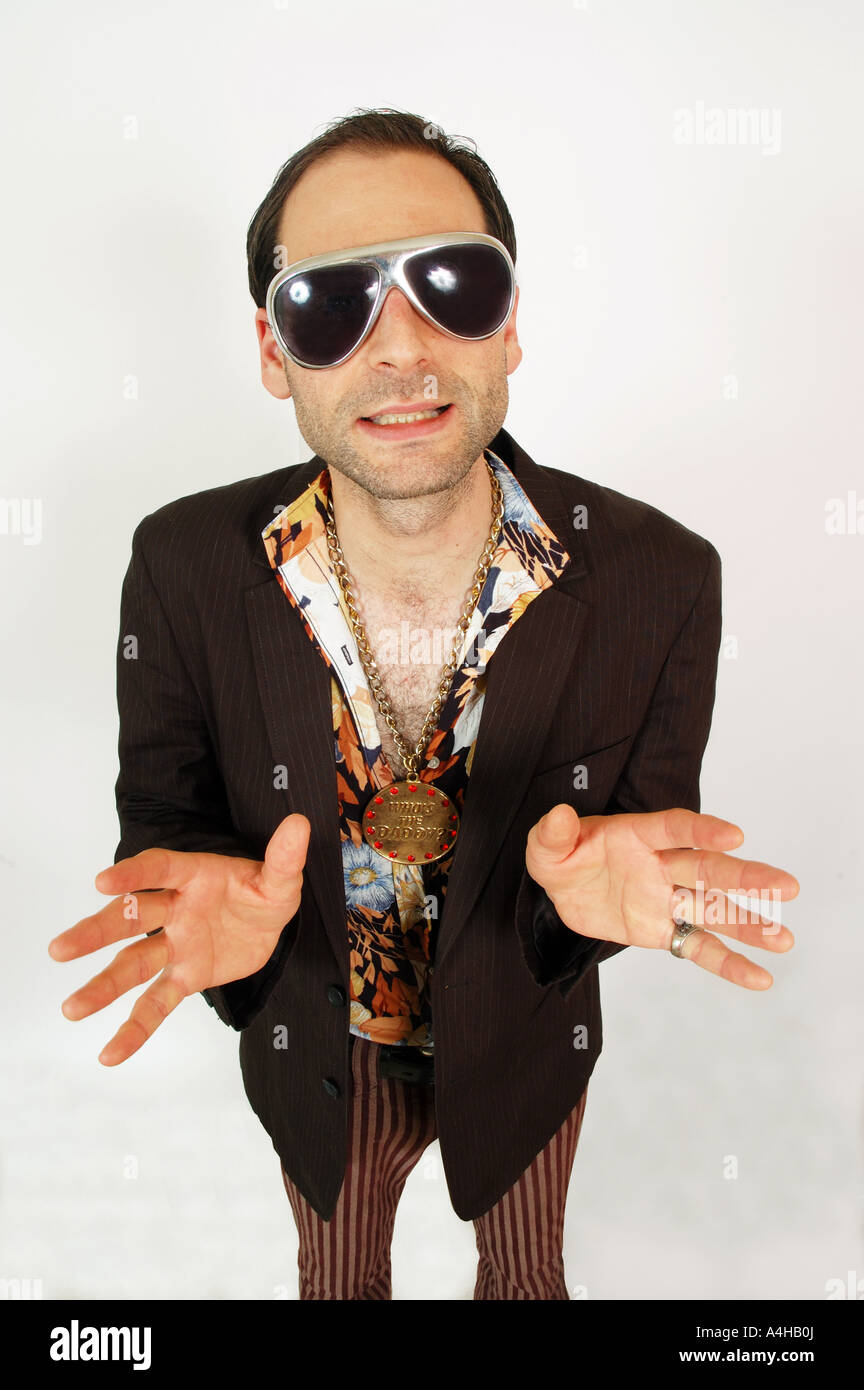 A sleazy looking man gesturing to camera Stock Photo - Alamy