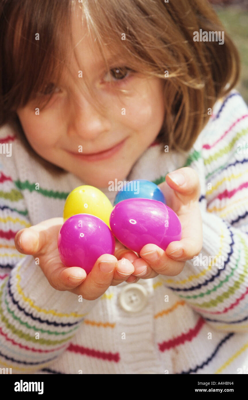 YOUNG GIRL (5-7 YRS) HOLDING PLASTIC EGGS Stock Photo