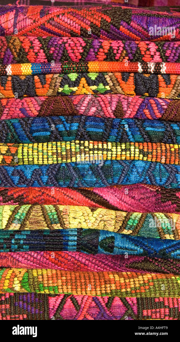 A stack of brightly brocaded textiles from Chichicastenango for sale on ...