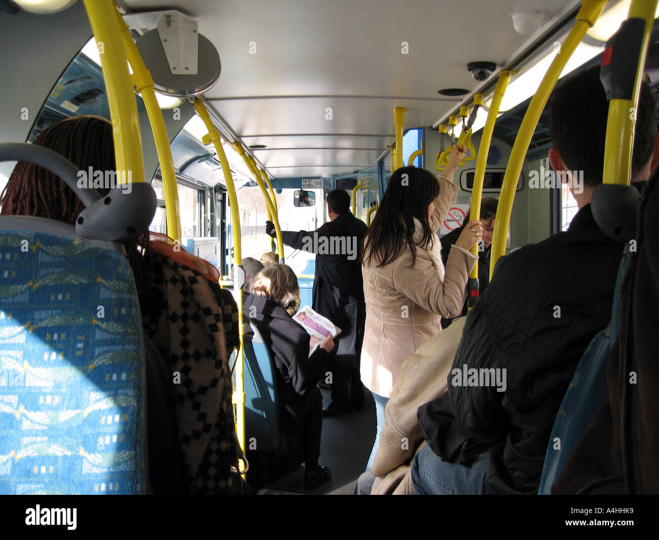 Interior of London Bendy Bus commuters standing Stock Photo