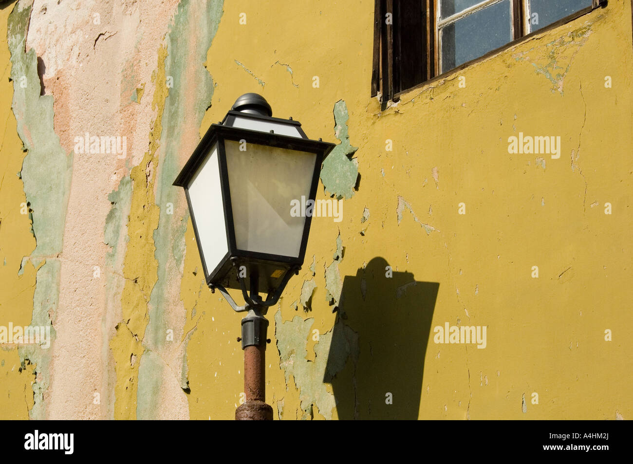 A street lamp with peeling wall paint background Old Plovdiv Bulgaria East Europe Stock Photo