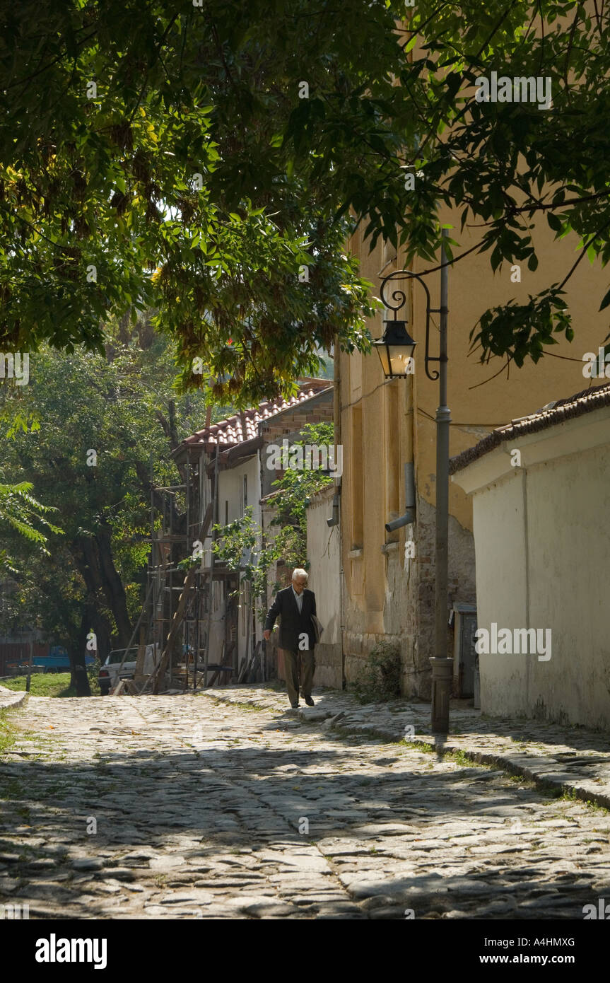 Old man walking in cobbled street old Plovdiv Bulgaria East Europe Stock Photo