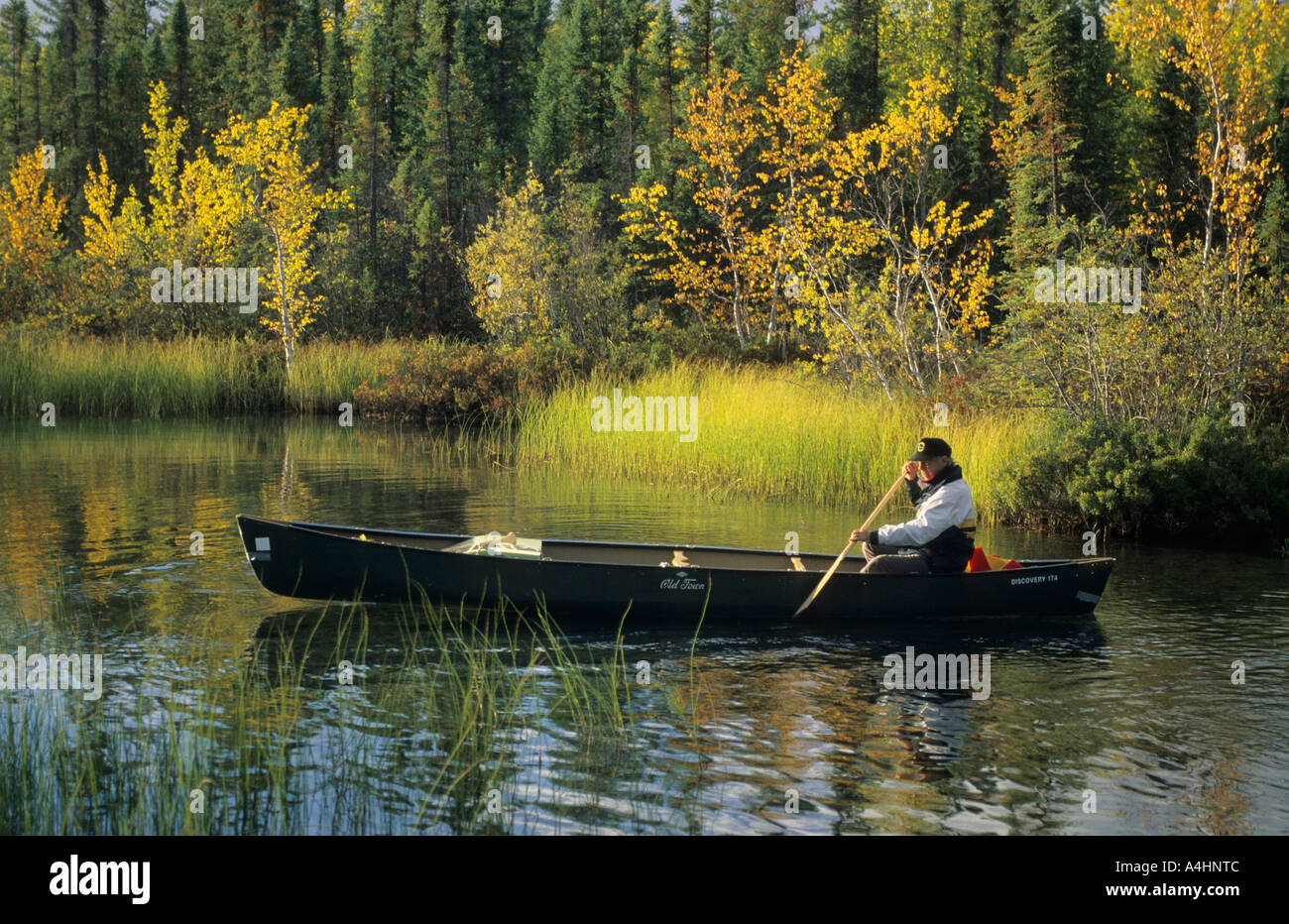 Man sitting in a canoe, Northwest Territories, Canada Stock Photo