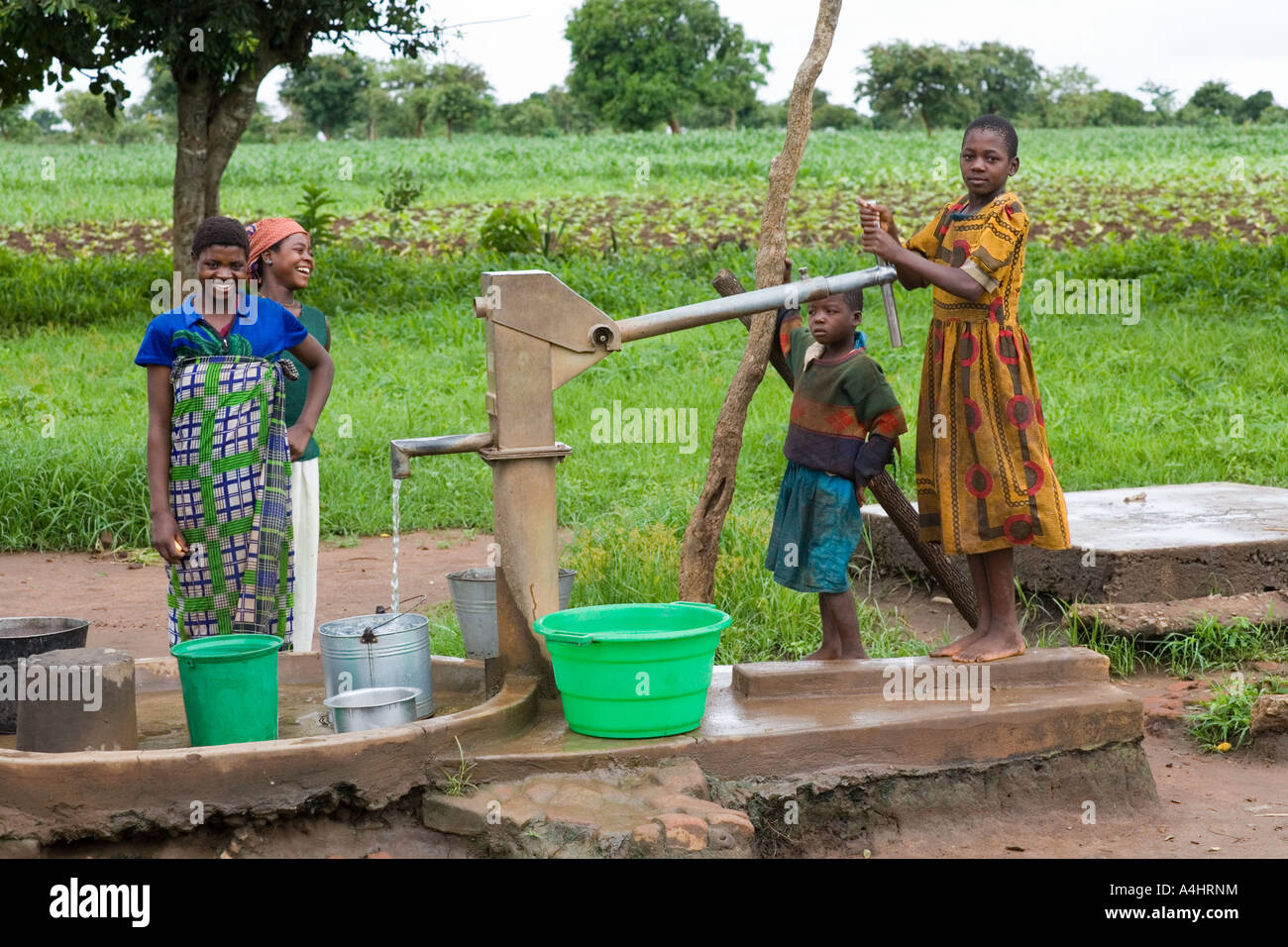 Women and children at the water pump in the village of Khoswe, Malawi