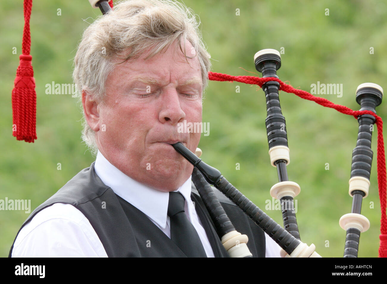 adult male playing bagpipes at Dundonald Highland Games, Ayrshire, Scotland Stock Photo