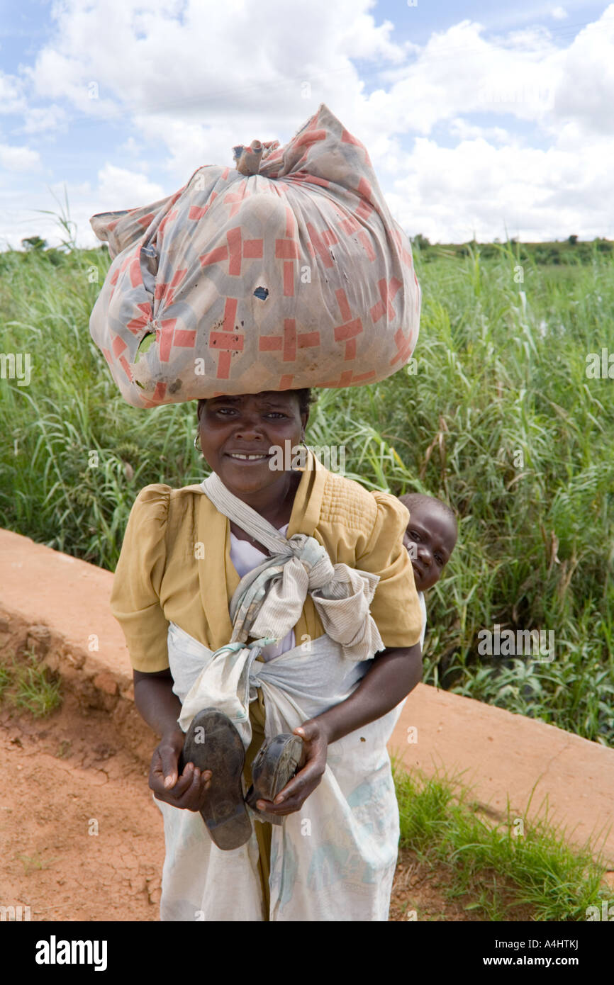 Lady carrying a bundle on her head and a baby near Makosana Malawi Africa  Stock Photo - Alamy