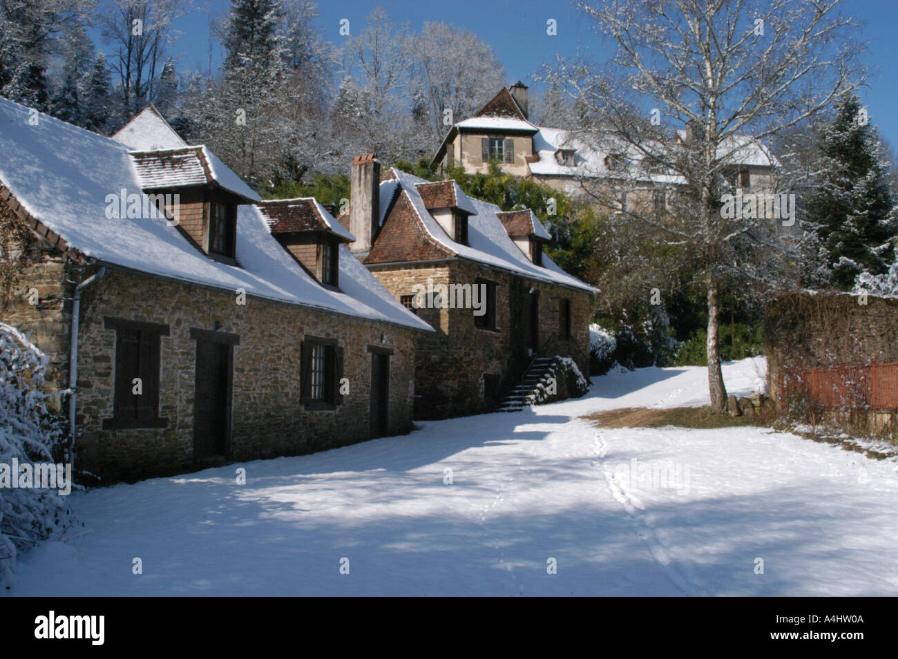 french holiday gites in the snow with trees Stock Photo
