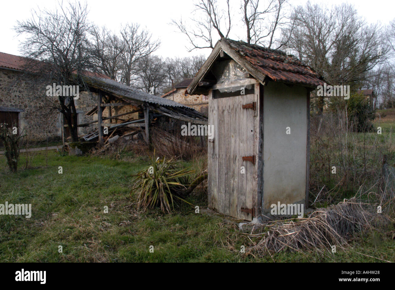outside toilet made of wood and tiles france st jean de cole Stock Photo
