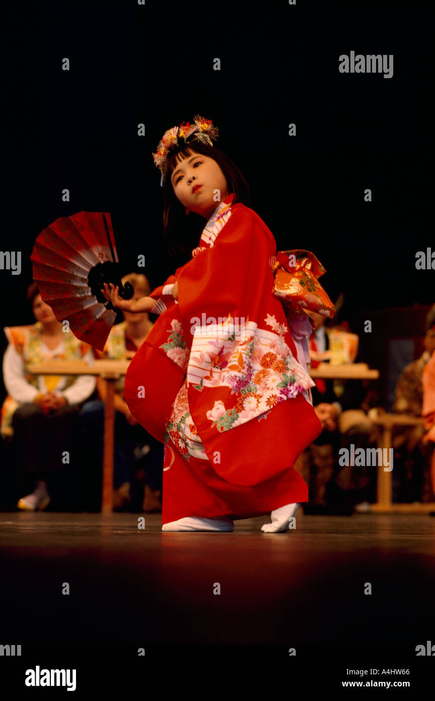 Young Japanese Girl Dancer from Ikuta Shinto Shrine in Japan wearing a Kimono and dancing Traditional Dance Performance on Stage Stock Photo