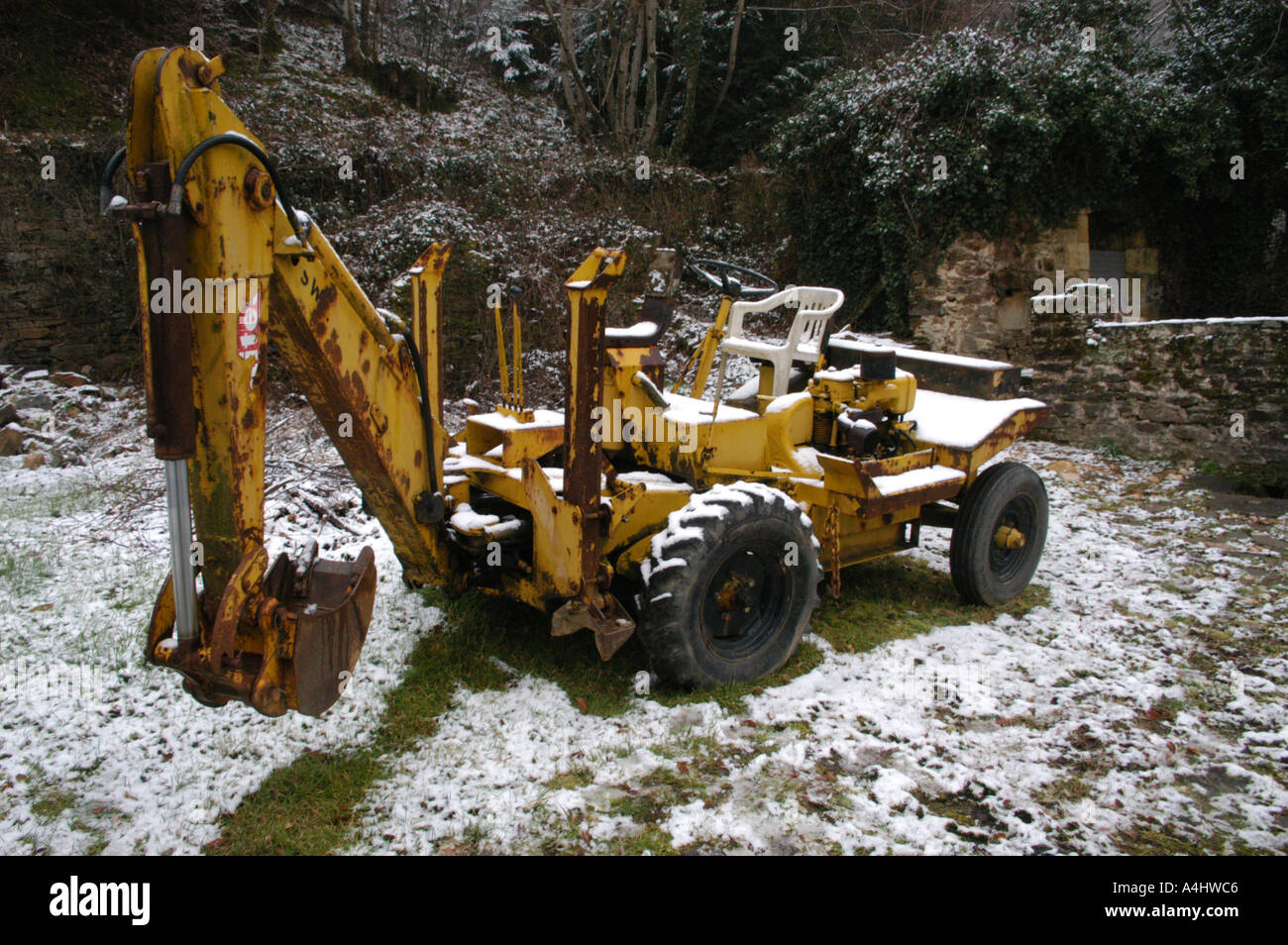 old hydraulic grave digger in the snow france Stock Photo