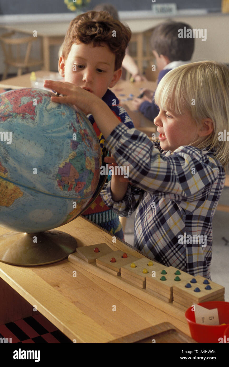 Preschool kids playing with a globe Stock Photo