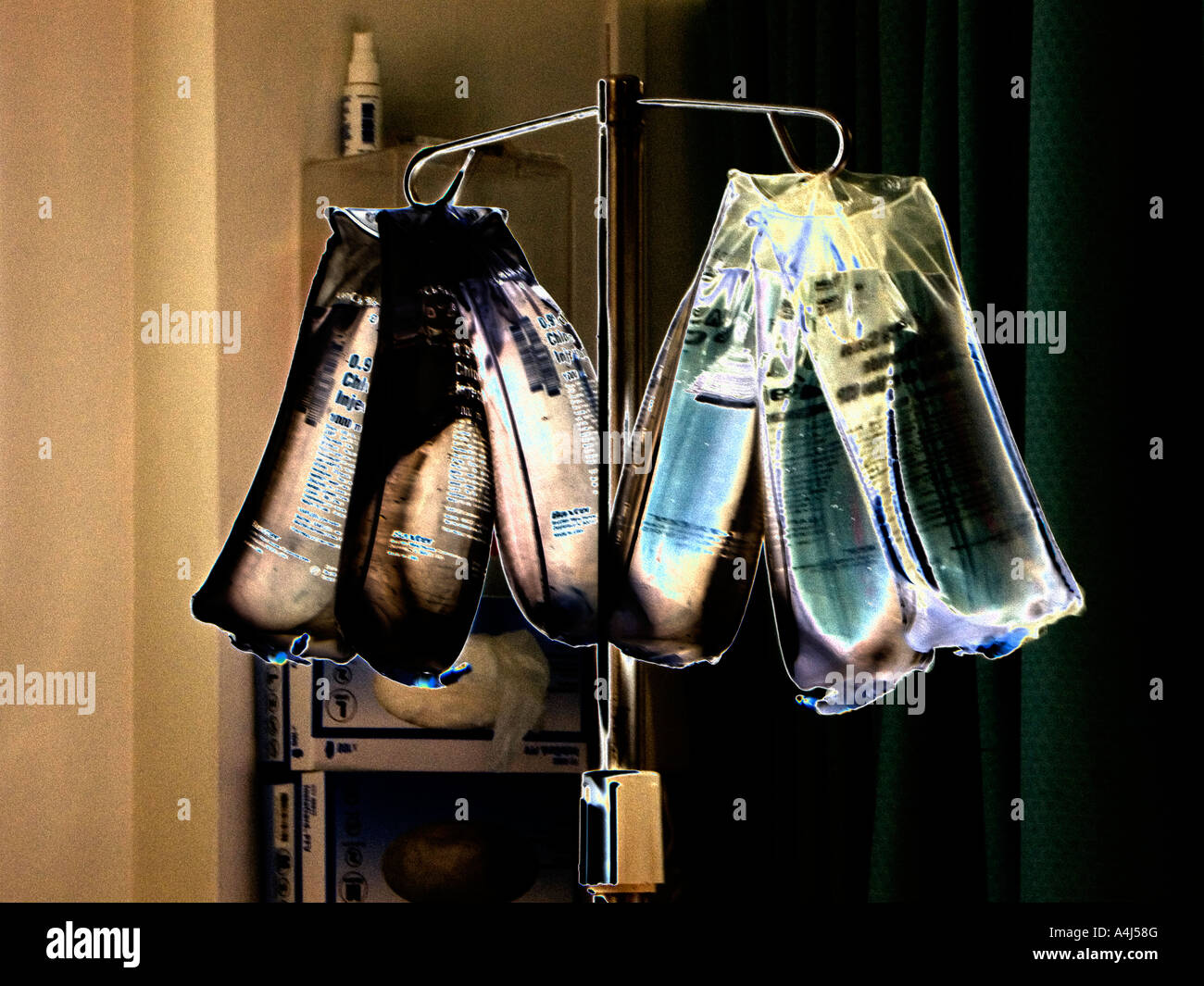 rack of IV intravenous bags hanging in hospital intensive care ward for