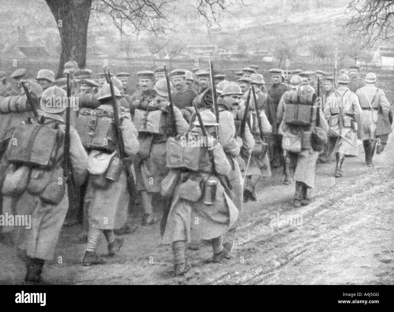 Relief French infantry passing a line of prisoners, Plessis-de-Roye, Picardy, France, 30 March 1918. Artist: Unknown Stock Photo