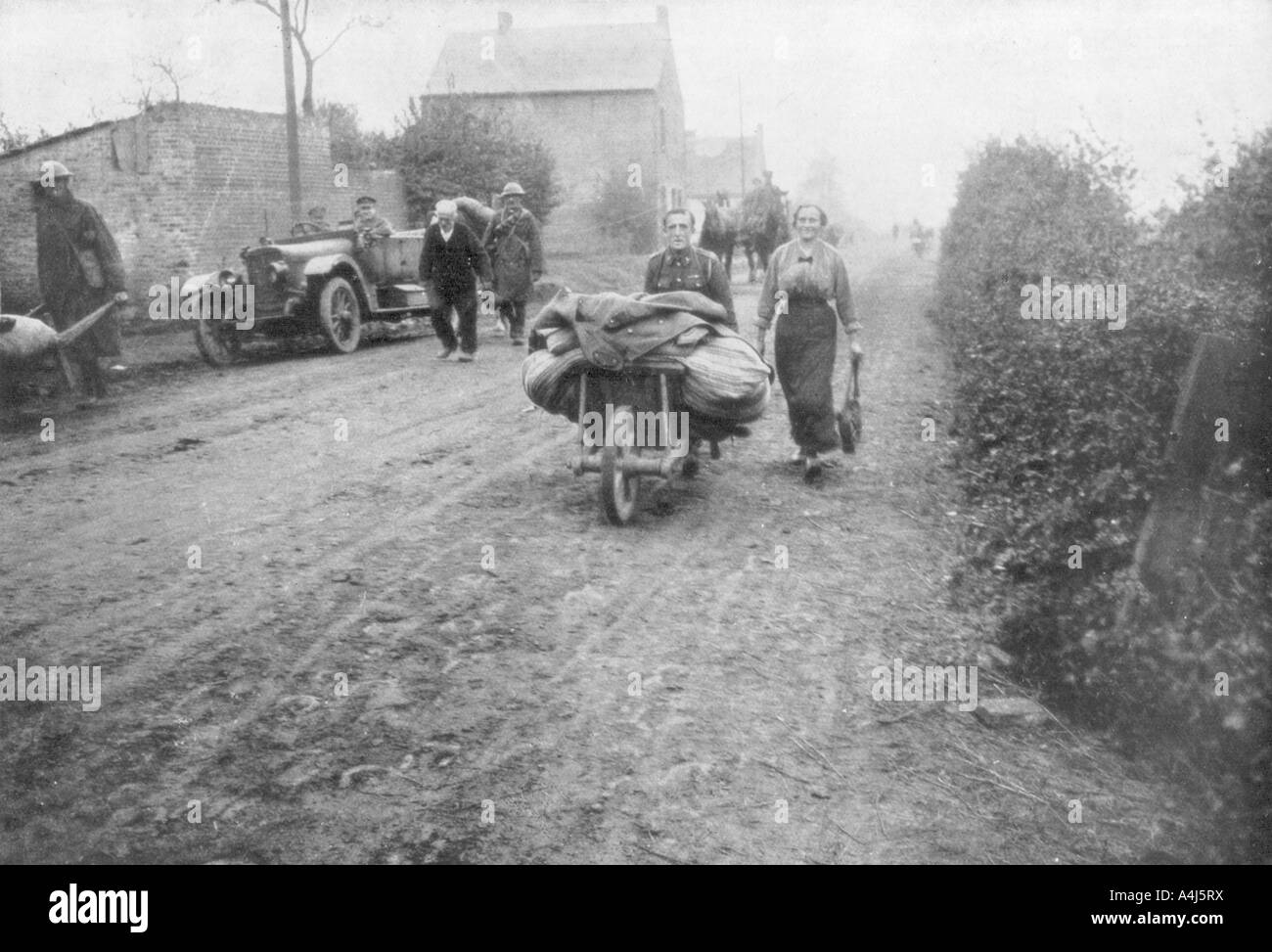 A British soldier helping a woman return to her village, France, 1918. Artist: Unknown Stock Photo