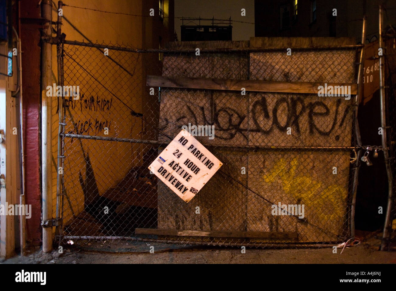 Gate and no parking sign at night Stock Photo