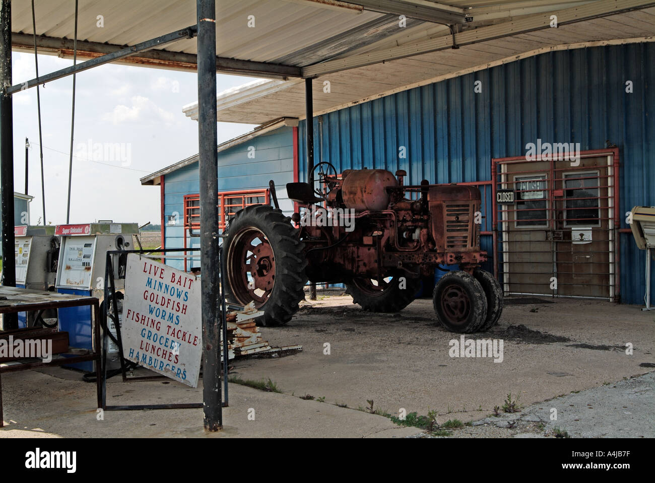 Old farm tractor parked under a shelter Stock Photo - Alamy