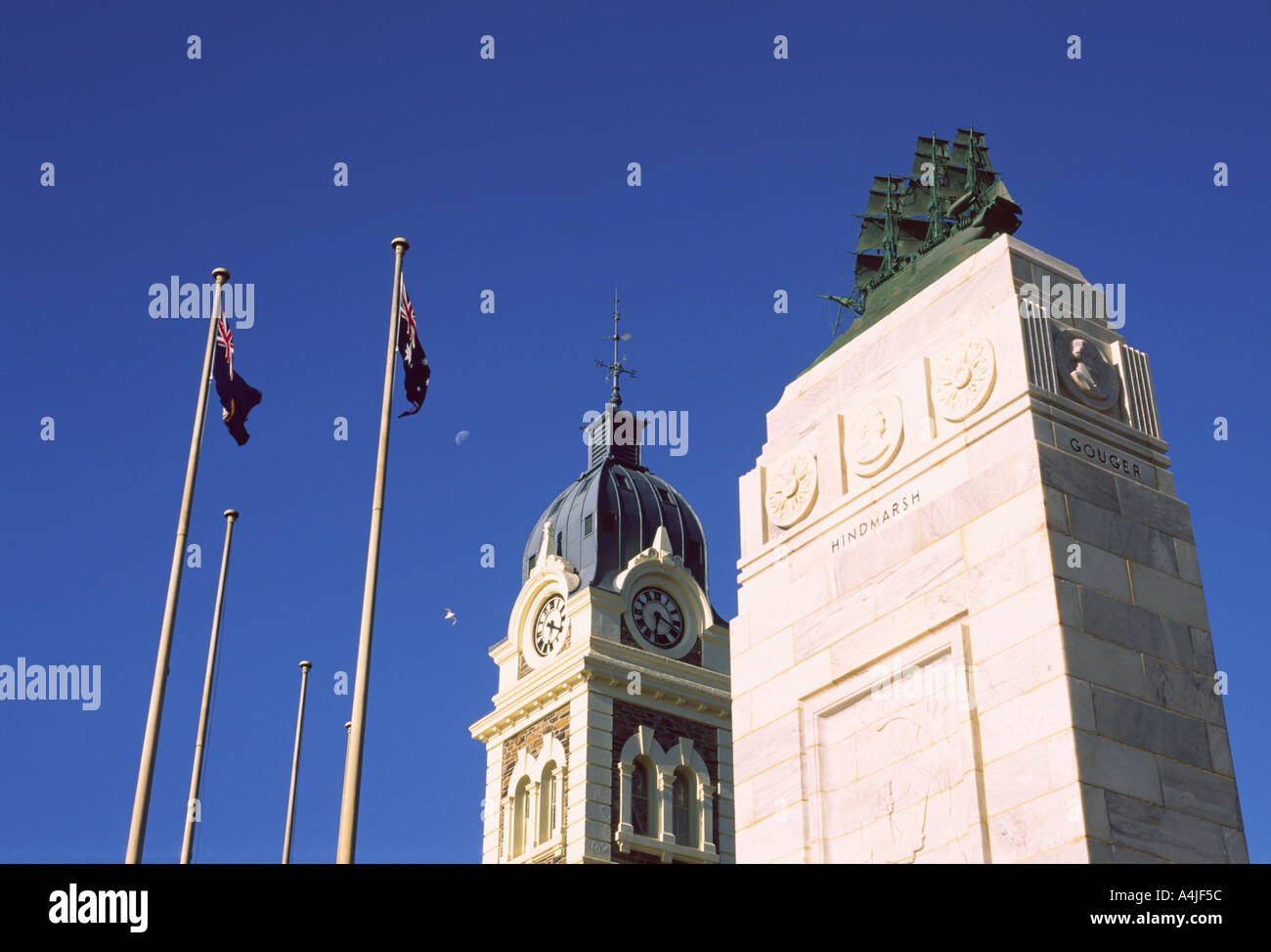 Glenelg South Australia Australian flags townhall clock tower founding memorial flying seagulls moon Stock Photo