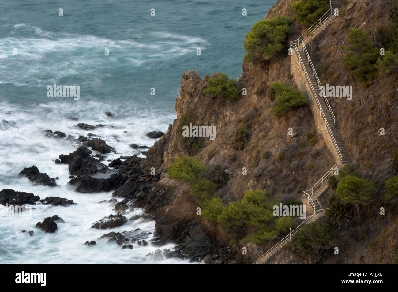 Stairway in the rock cliffs in the Mediterranean seashore Nerja Málaga Spain Stock Photo