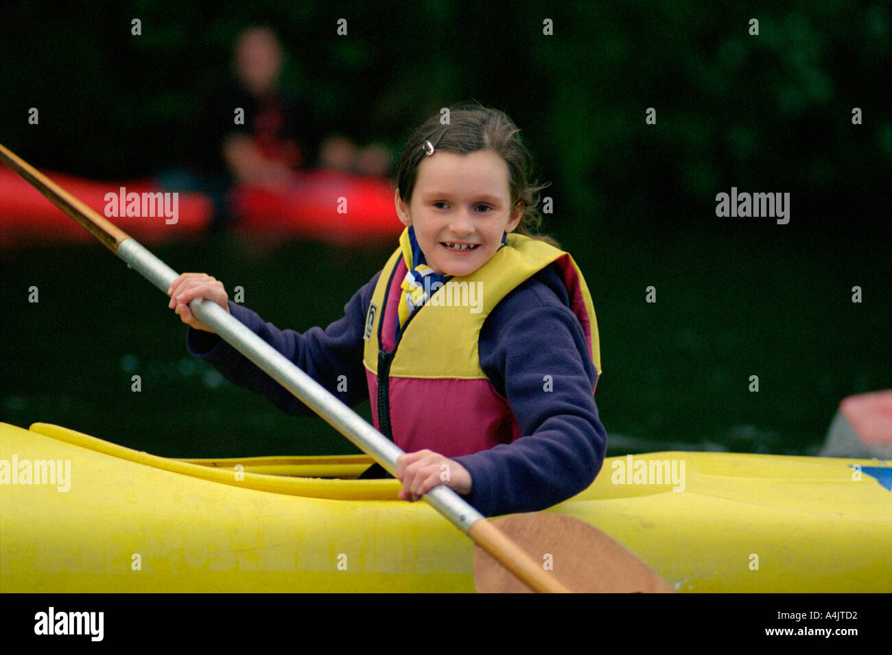 young scout canoeing at camp on river thames nr London uk england