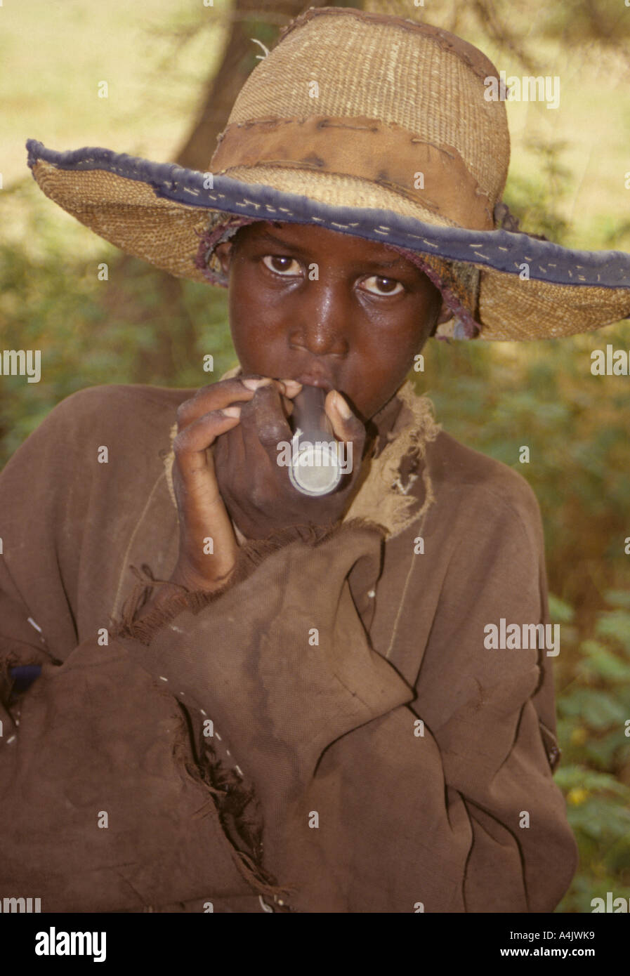Boy with Drinking Tube Filter to Avoid Ingesting Guinea Worm, Niger. Stock Photo