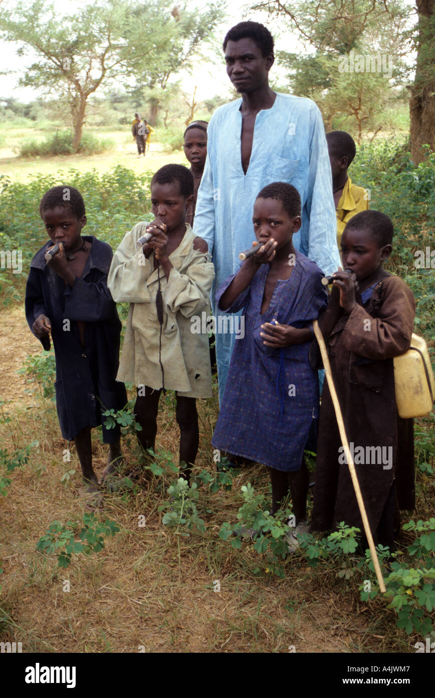 Boys with Drinking Tube Filters to Avoid Ingesting Guinea Worm, Niger. Stock Photo