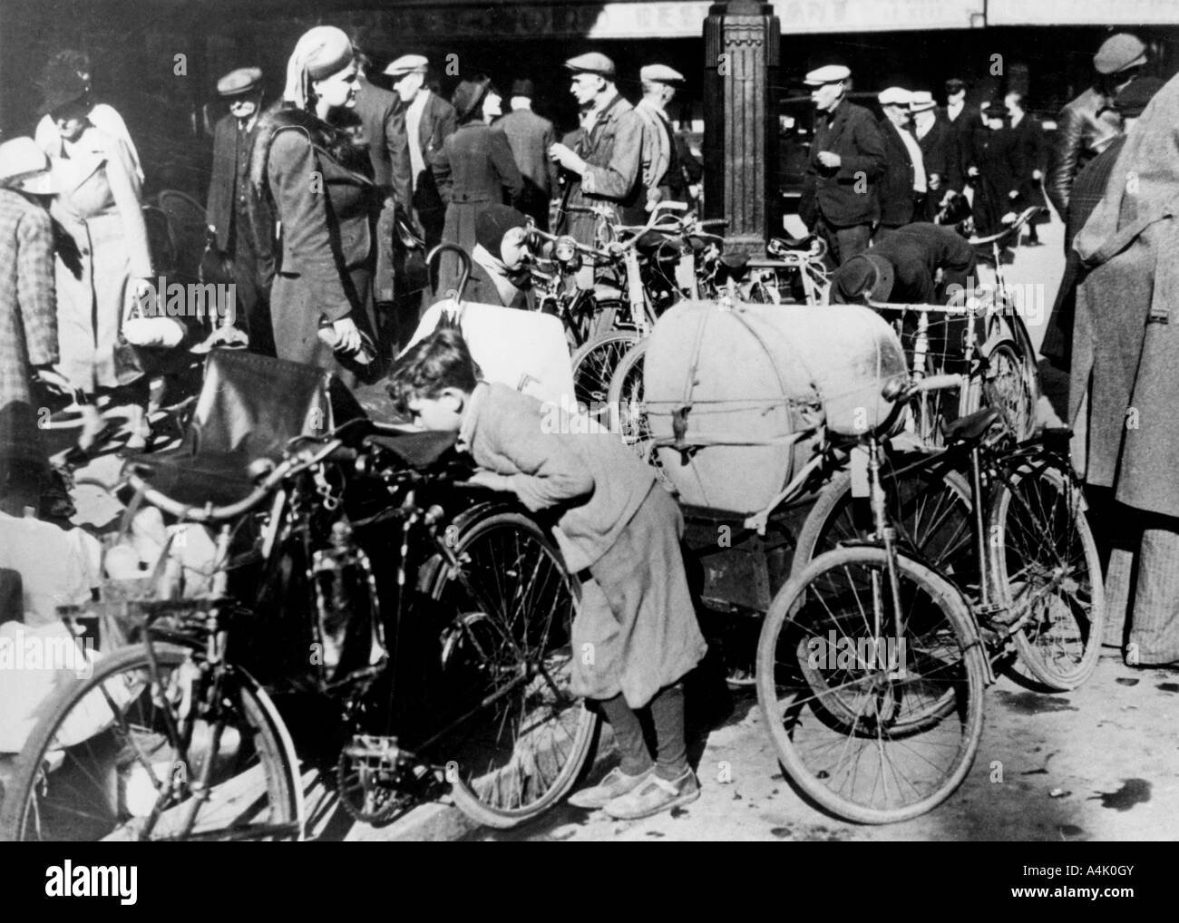 Belgian refugees with their bicycles and possessions outside the Gare du Nord, Paris, July 1940. Artist: Unknown Stock Photo