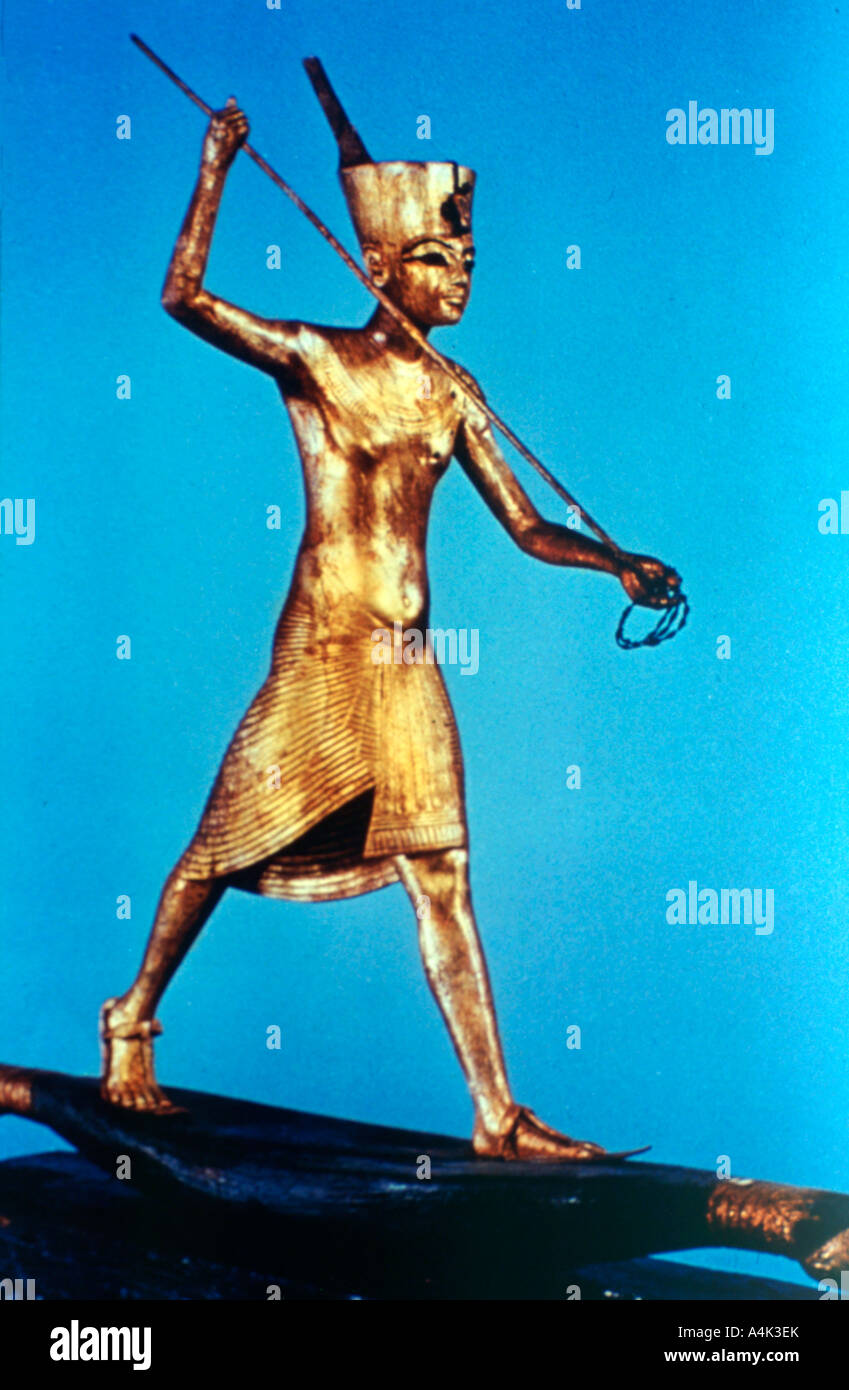 Gold figure of King Tutankhamun standing on a reed boat and spearing fish, 14th century BC. Artist: Unknown Stock Photo