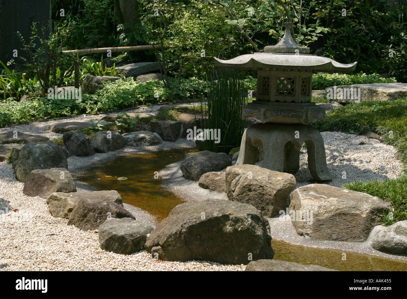 Stone garden lantern stands in sunlight at a temple garden in Kamakura Tokyo Japan Asia Stock Photo