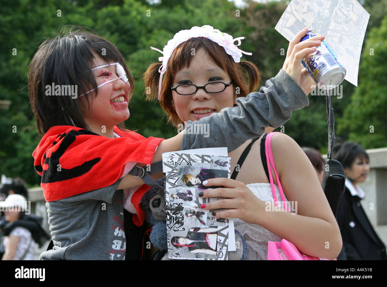 Japanese teenagers drinking chu hi alcohol dressed in urban street fashion Tokyo Japan Asia Stock Photo