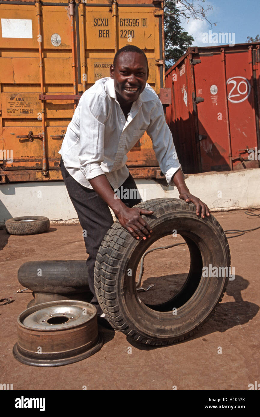 Man repairing a car tire at a local repair service, Moshi, Tanzania Stock Photo